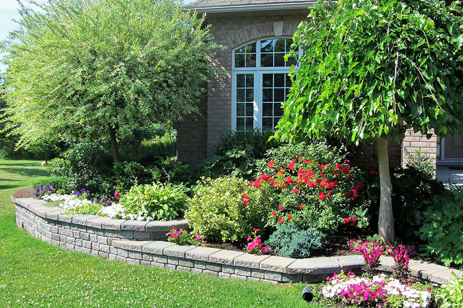 A beautiful home with professional landscaping including shrubs, small trees, flowers, and more in Collinsville, IL.