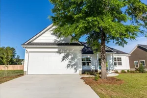 A-Unlimited Tree Service—The exterior of a home in Edwardsville, IL, with a tree shading the front of the house.