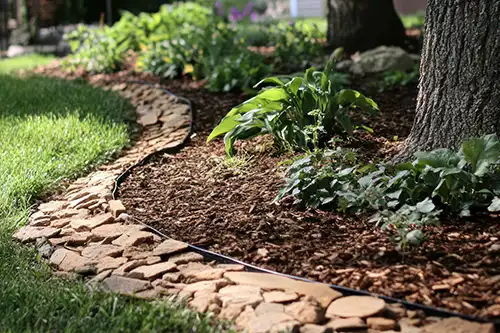A-Unlimited Tree Service—A garden in Maryville, IL, with trees and plants that have been mulched during the summer.