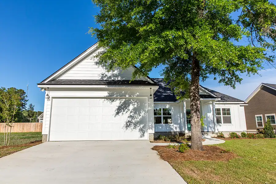 A-Unlimited Tree Service—The exterior of a home in Edwardsville, IL, with a tree shading the front of the house.